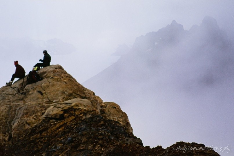Two companions pause to look at the view in the Masson ranges, Frames Mountains as the mist starts to roll in.