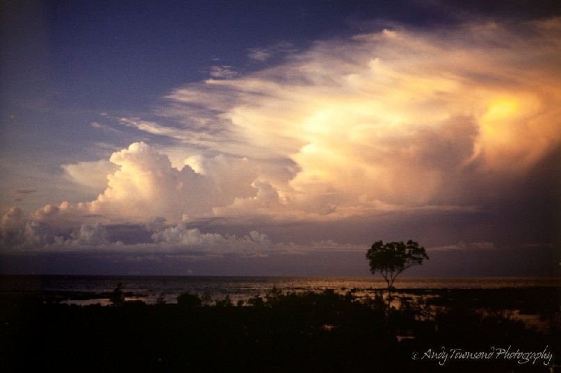 The last of the sun's rays hit storm clouds as they approach Darwin in the build-up season.