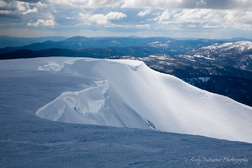 A cornice of snow and ice flanks the northern edge of Watsons Crags on the main range.