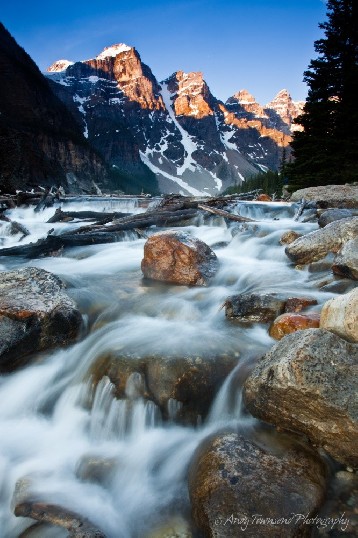Water cascades down the falls below Moraine Lake in the Canadian rockies.