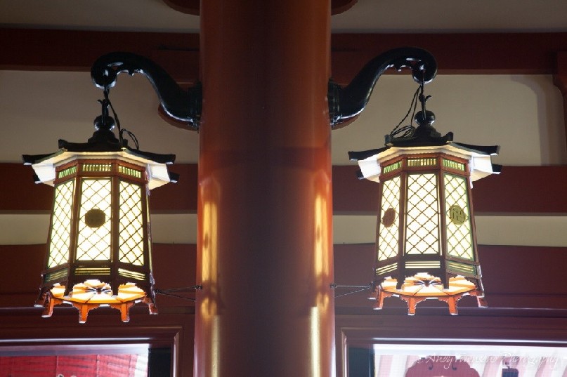 Two ornate lanterns adorn this pole.