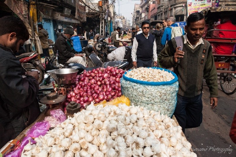 Mounds of garlic adorn this street stall at a wholesale vegetable market.