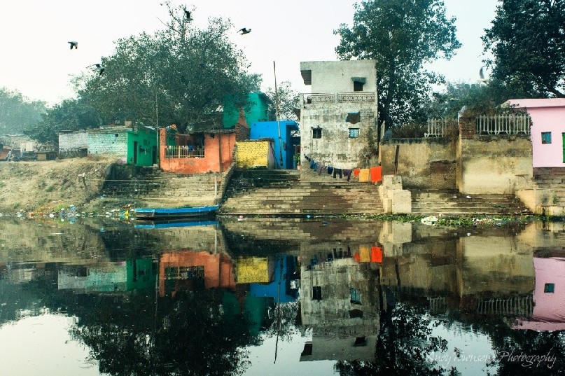 Reflections of old building from the Yamuna river in Delhi.