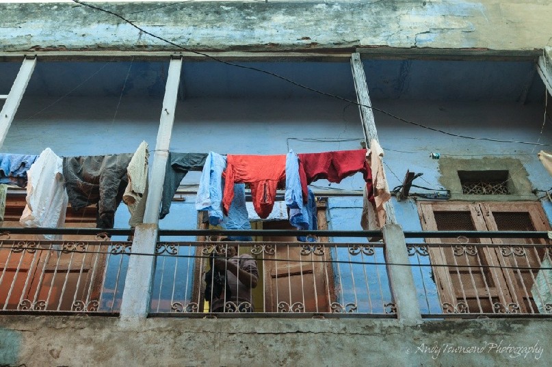 A clothes line above a busy city street.