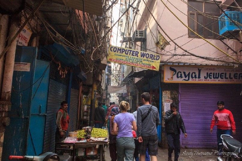 People walking through a busy alleyway in Old Delhi.