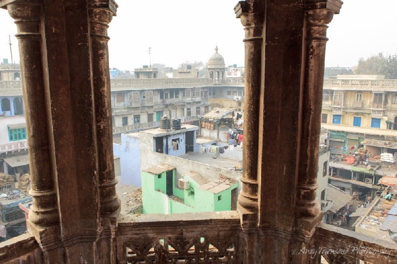 Looking through old stone pillars into the wholesale spice market in Chandni Chowk.
