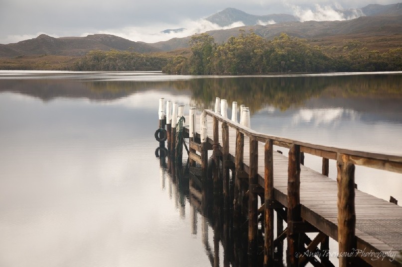 A jetty sits in the quiet tranquil waters in Bathurst Harbour, Southwest National Park, Tasmania.
