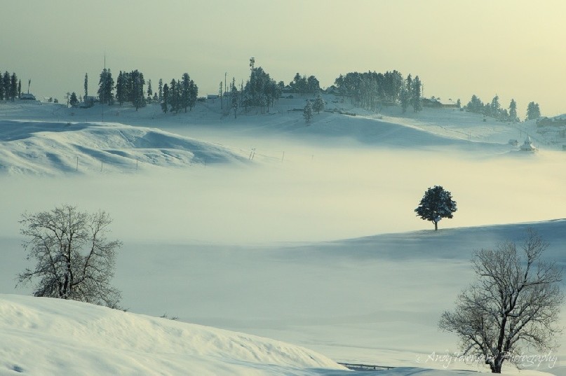 A layer of mist over covers the lower parts of Gulmarg.