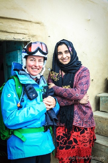 Two woman, a skier and local, enjoy a portrait together in Drung village.