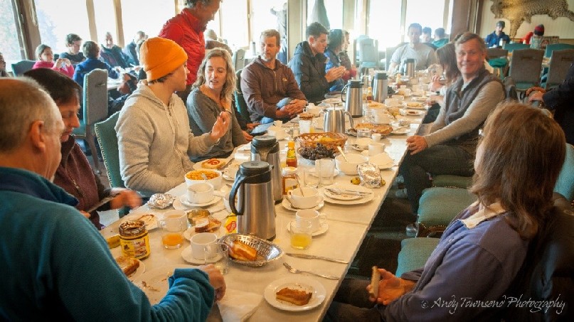 A group of skiers enjoying breakfast.