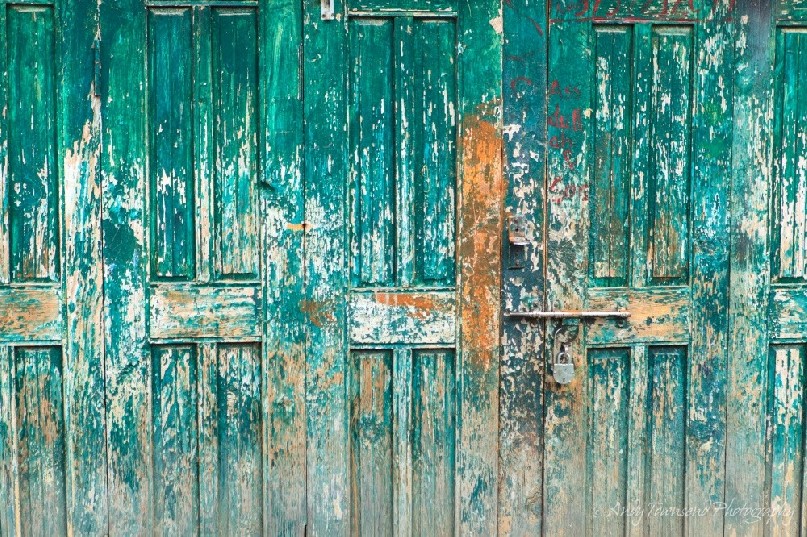 A turquoise wooden door on a house near Drung village.