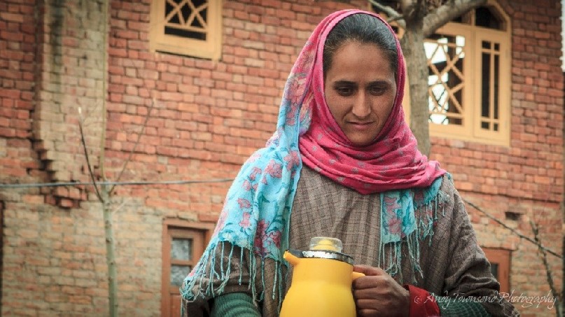 A woman prepares to serve Kashmiri tea in the village of Heer, near Targmarg.