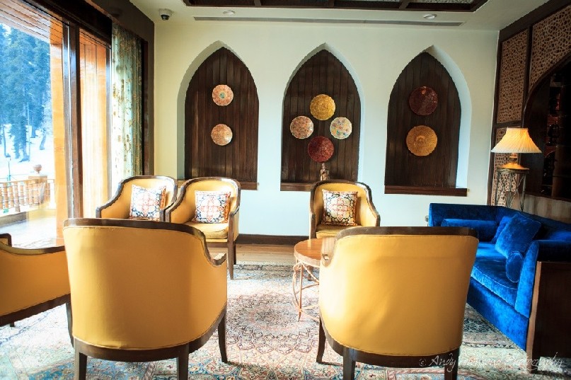 A Khyber resort lounge area showing seats, coucha and wall decorations.